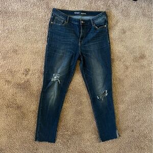 High Rise dark wash skinny jeans with a distressed look.